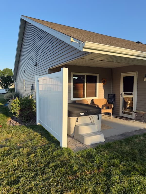 White vinyl privacy fence screening a residential patio